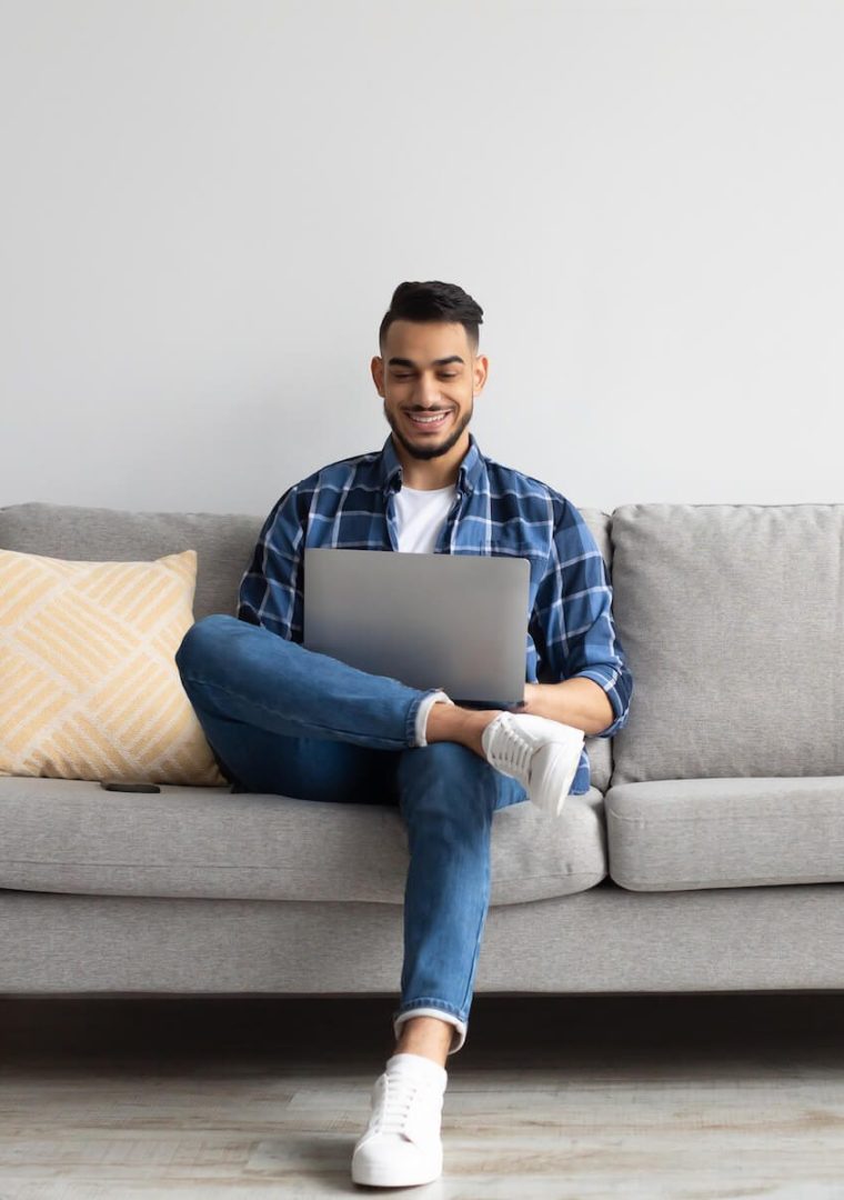 portrait-of-smiling-arab-man-using-laptop-at-home-2022-10-07-02-34-51-utc-e1668133197900.jpg